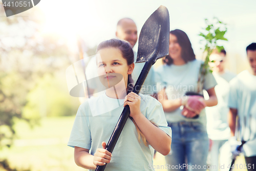 Image of group of volunteers with trees and rake in park