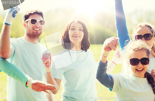 Image of group of volunteers celebrating success in park