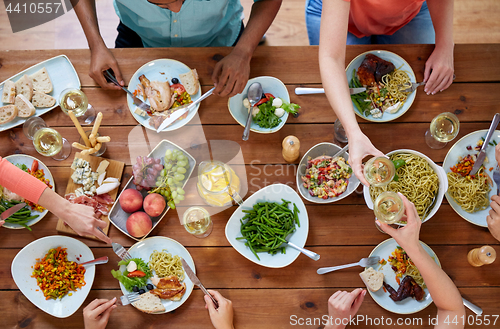 Image of group of people eating at table with food