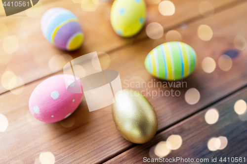 Image of close up of colored easter eggs on wooden boards