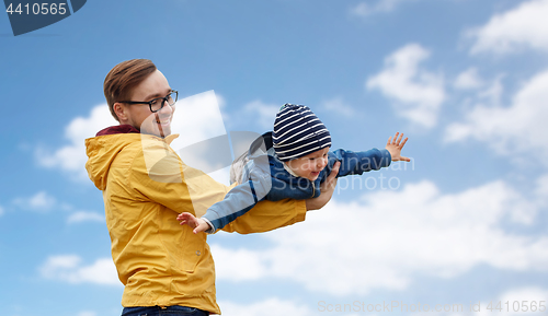 Image of father with son playing and having fun outdoors