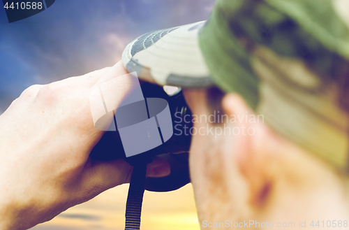 Image of close up of soldier looking to binocular