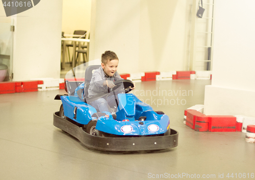 Image of Boy in bumper car driving autoscooter