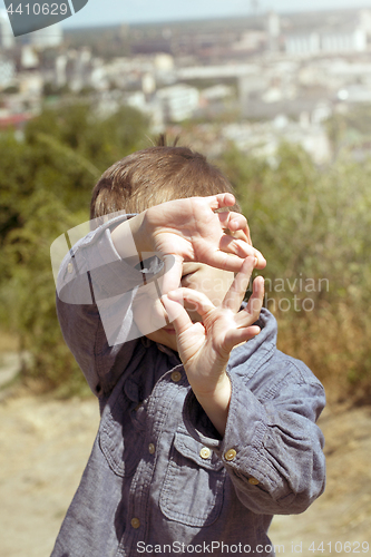 Image of Boy pretending that he is a cameraman