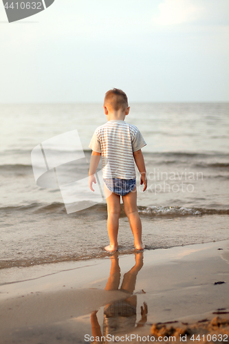 Image of Happy boy playing on the beach