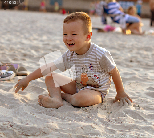 Image of Happy boy playing on the beach