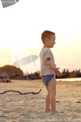 Image of Happy boy playing on the beach