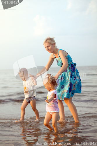 Image of Happy family playing on the beach