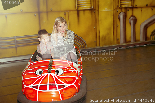 Image of Mother and son driving autoscooter