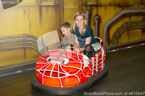 Image of Mother and son driving autoscooter