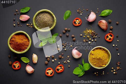 Image of various spices on black background