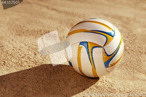 Image of white ball on sand