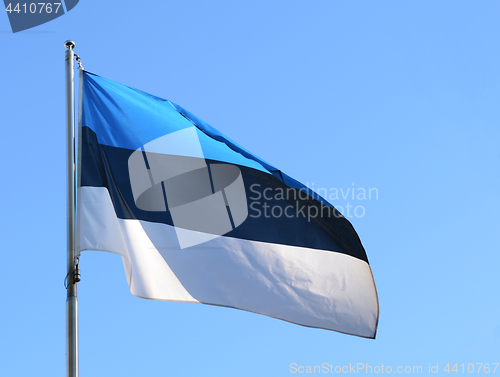 Image of National flag of Estonia against a blue sky