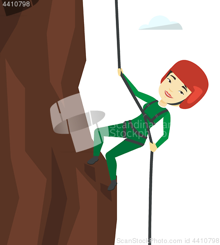 Image of Woman climbing in mountains with rope.