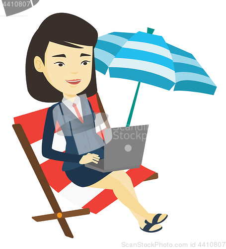 Image of Business woman working on laptop at the beach.