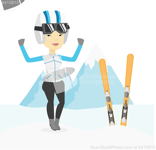 Image of Cheerful skier standing with raised hands.