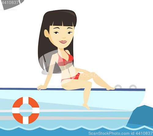 Image of Young happy woman tanning on sailboat.