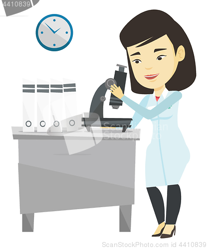 Image of Laboratory assistant with microscope.