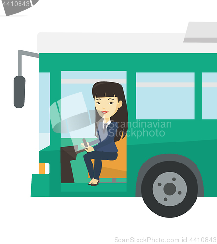 Image of Asian bus driver sitting at steering wheel.