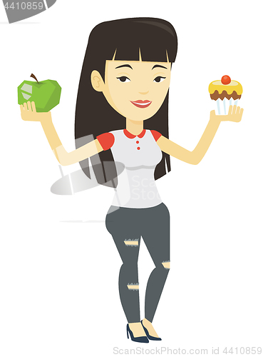 Image of Woman choosing between apple and cupcake.