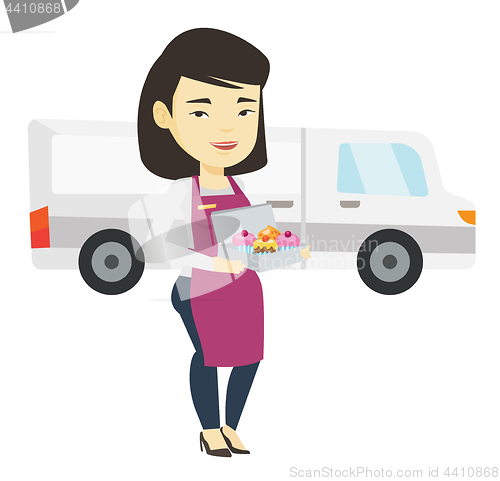 Image of Delivery woman holding a box of cakes.