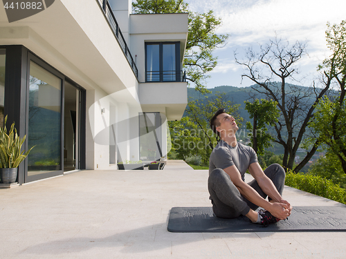 Image of man doing morning yoga exercises