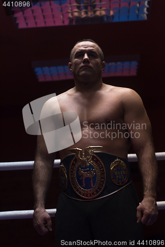 Image of kick boxer with his championship belt