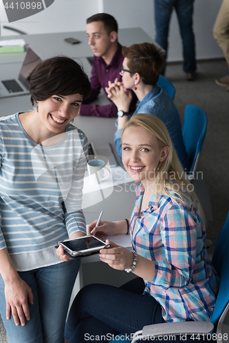 Image of Pretty Businesswomen Using Tablet In Office Building during conf