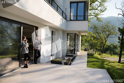 Image of couple enjoying on the door of their luxury home villa