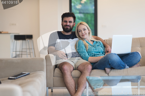 Image of young happy couple relaxes in the living room