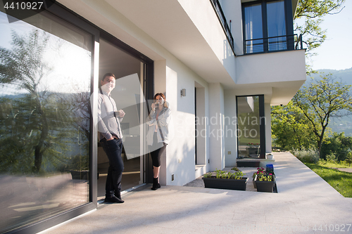 Image of couple enjoying on the door of their luxury home villa