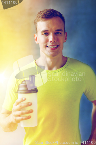 Image of smiling man with protein shake bottle