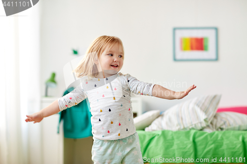 Image of happy little girl having fun at home