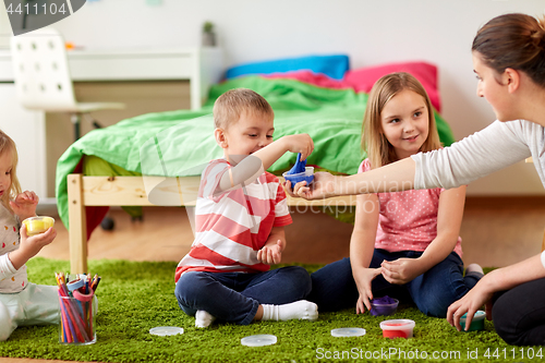 Image of kids and mother with modelling clay or slimes