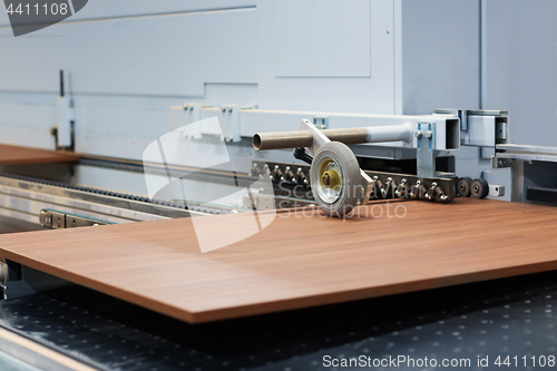 Image of wooden board on conveyer at furniture factory