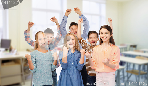 Image of happy students celebrating victory at school