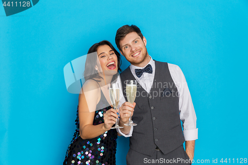 Image of happy couple with champagne glasses at party