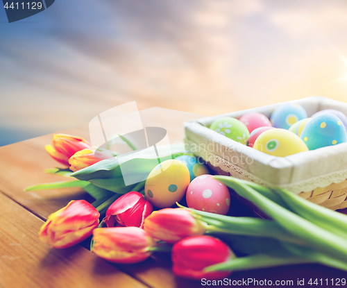 Image of close up of easter eggs and flowers on table