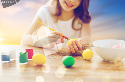 Image of close up of girl coloring easter eggs