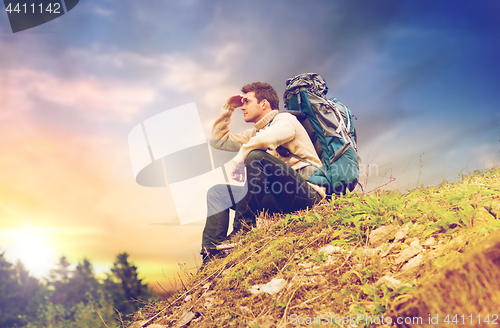 Image of traveler with backpack hiking over sky background