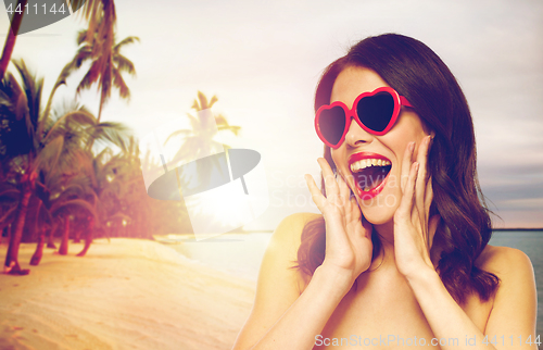 Image of woman with red lipstick and heart shaped shades