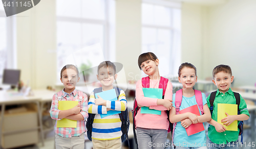 Image of happy children with school bags and notebooks