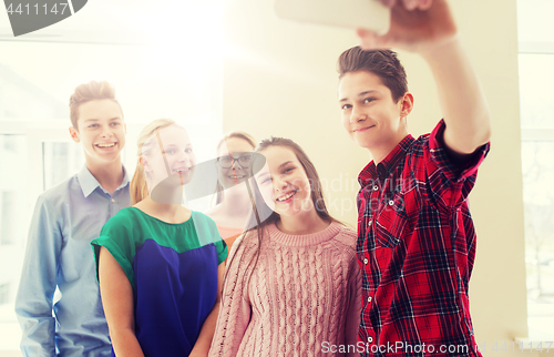 Image of group of students taking selfie with smartphone