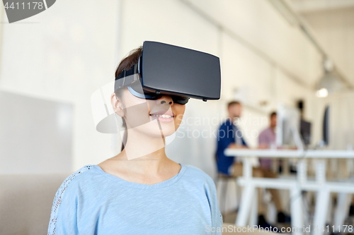Image of happy woman with virtual reality headset at office