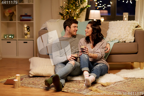 Image of happy couple drinking coffee and eating at home