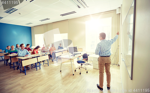 Image of students and teacher at school white board