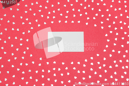 Image of Blank card on pink background with shiny hearts