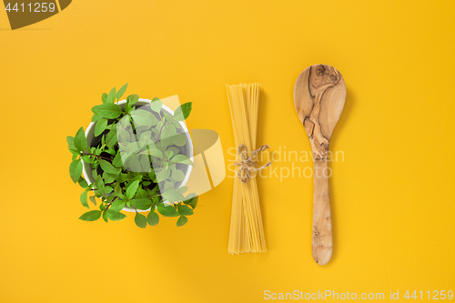 Image of Basil, pasta and wooden spoon