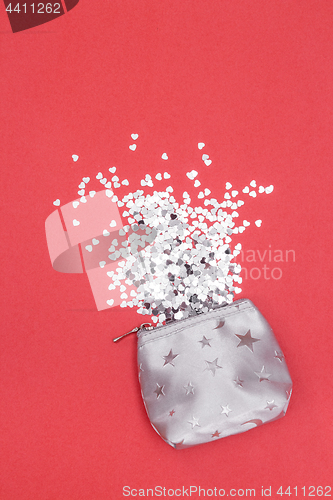 Image of Shiny hearts spilling out of a silver purse