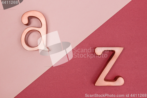 Image of Metal letters on pink and cherry red background